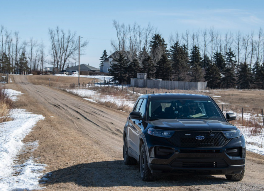 <who> Photo credit: Canadian Press </who> Black unmarked RCMP vehicles could be seen blocking roads leading to a Saskatchewan farm property as officers continued to investigate the suspicious deaths of four people.