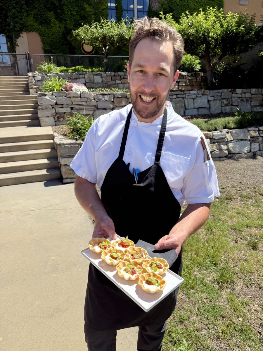 <who>Photo credits: Steve MacNaull/NowMedia Group</who>Mission Hill Family Estate executive chef Patrick Gayler with mascarpone and goat cheese tarts in the estate garden.