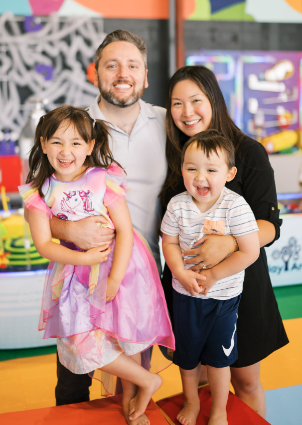 <who> Photo credit: Gavin Dew </who> Dew with his wife and children at the couple's new play centre.