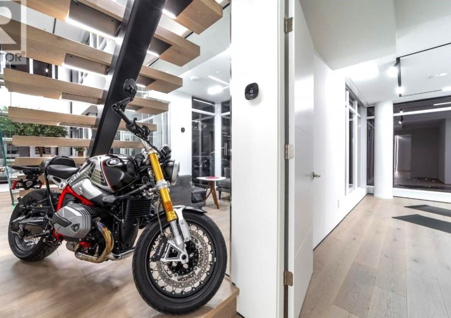 </who>This classic roadster BMW motorcycle is a showpiece parked in the 'Skye Home' penthouse condo that's listed for sale for $3.5 million. Below, a similar bike on the street.