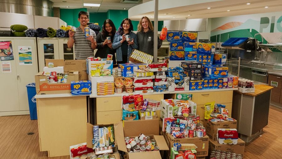 <who>Photo Credit: UBCO</who>Stephanie Patterson, far right, Food Security and Nutrition Manager with the Student Union of UBC Okanagan, helped students Maki Benedicto, Omana Pisharoty and Ana Cortes unload donated items when the Food for Fines program came to an end last month.